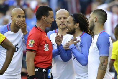 United States midfielder Jermaine Jones, second from right, protests to referee Wilmar Roldan, second from left, after Roldan gave Jones a red card in the second half of a Copa America Centenario soccer match against Ecuador, Thursday, June 16, 2016 at CenturyLink Field in Seattle. The United States beat Ecuador 2-1. (AP Photo/Ted S. Warren)