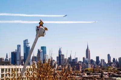 A utility worker watches the Navy's Blue Angels and the Air Force's Thunderbirds conduct "a collaborative salute" with a flyover of New York and New Jersey. AP