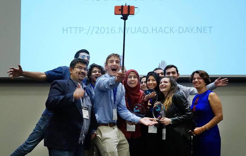 The winners of the hackathon competition celebrate with their trophy. The team also claimed the Audience Choice Award for the competition.  Delores Johnson / The National