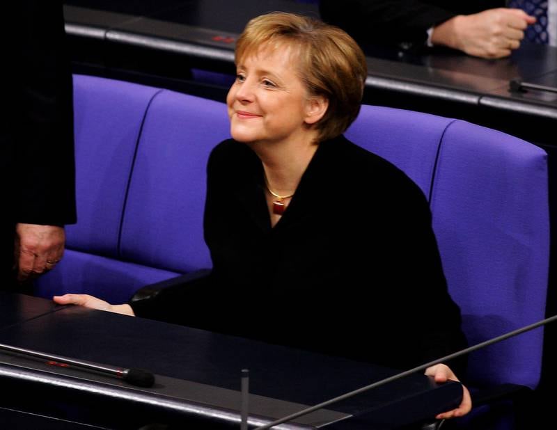 Mrs Merkel smiles as she sits in the chancellor's chair for the first time at the German lower house of parliament in November 2005. Getty Images