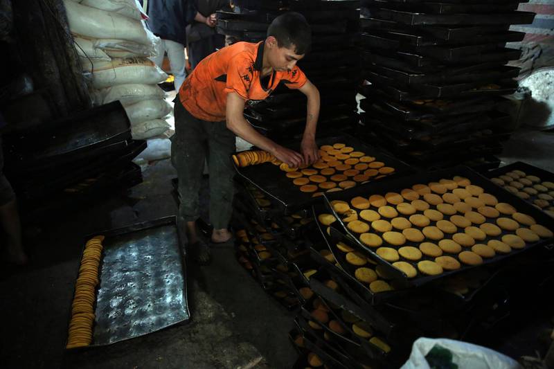An Afghan boy prepares sweets at a traditional bakery for Eid Al Fitr holiday to mark the end of Ramadan. AP