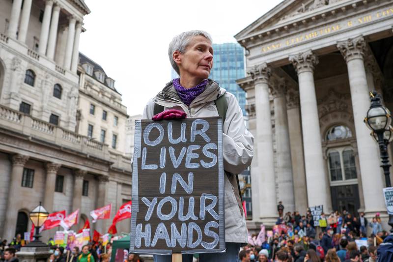 A demonstrator holds a banner during a climate protest in London. Reuters