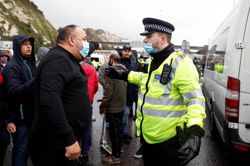 A driver talks with a police officer at the entrance of the Port of Dover, as EU countries impose a travel ban from the UK following the coronavirus disease (COVID-19) outbreak, in Dover, Britain, December 23, 2020. REUTERS/John Sibley
