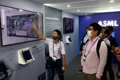 An ASML staff gives a tour to guests inside their innovation truck at SEMICON Taiwan in Taipei, Taiwan, September 14, 2022. REUTERS/Ann Wang