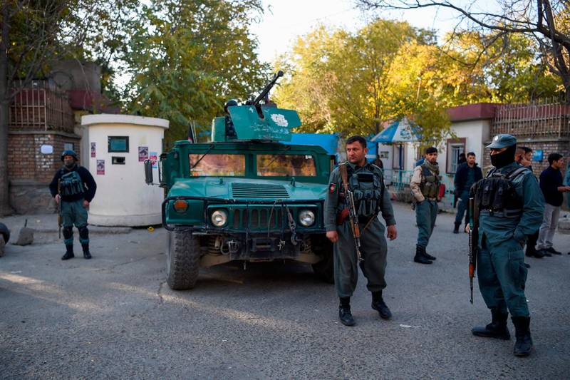 Policemen stand guard at an entrance of the Kabul university a day after gunmen stormed the university in Kabul on November 3, 2020. Stunned students demonstrated outside Kabul University on November 3 after at least 22 people were killed in a brutal, on-campus attack claimed by the Islamic State group. / AFP / Wakil KOHSAR
