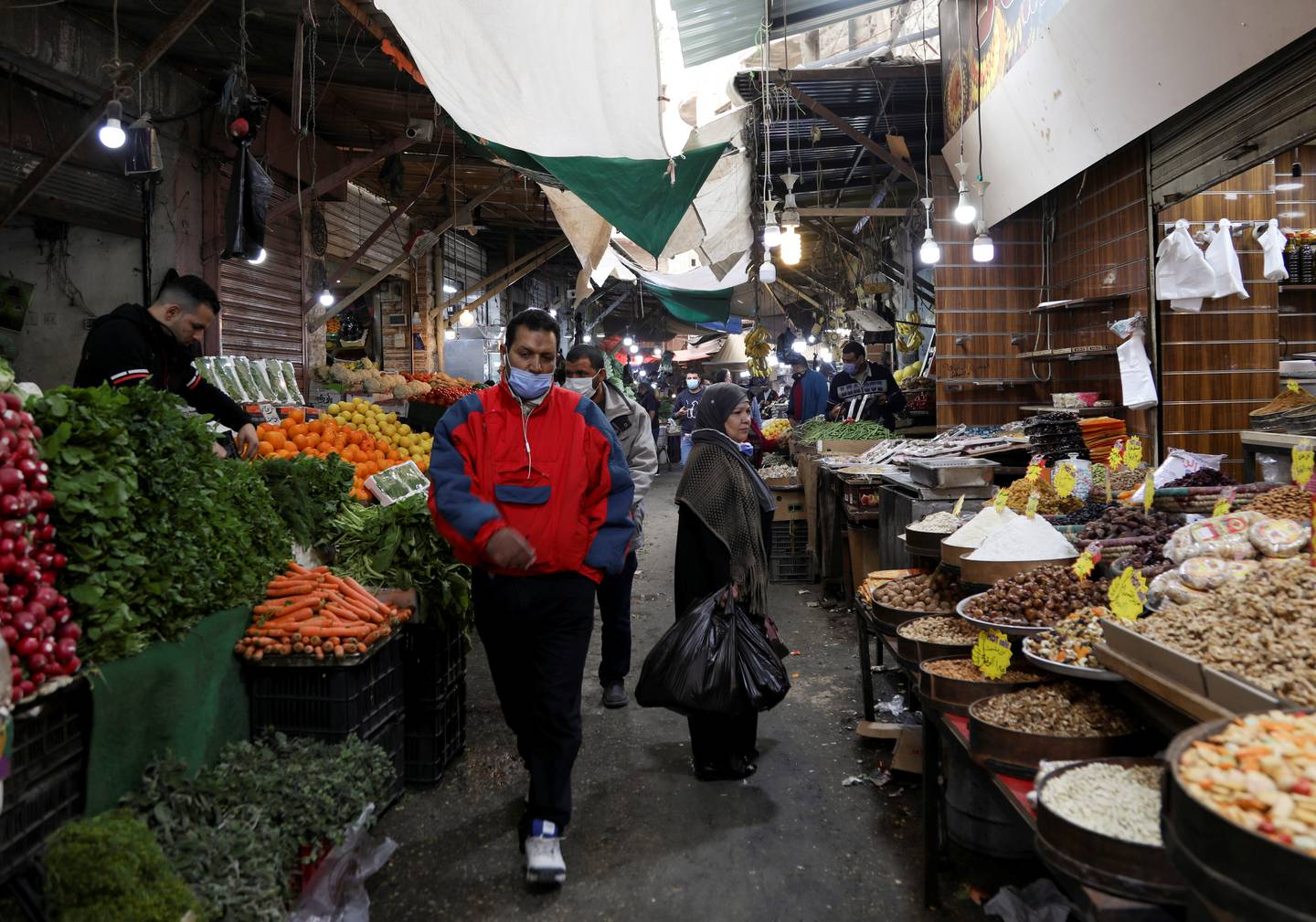 People walk at a market, amid concerns about the spread of the coronavirus in Amman, Jordan. Reuters