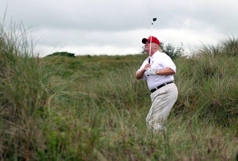 ABERDEEN, SCOTLAND - JULY 10:  Donald Trump plays a round of golf after the opening of The Trump International Golf Links Course on July 10, 2012 in Balmedie, Scotland. The controversial Â£100m course opens to the public on Sunday July 15. Further plans to build hotels and homes on the site have been put on hold until a decision has been made on the building of an offshore windfarm nearby. (Photo by Ian MacNicol/Getty Images)