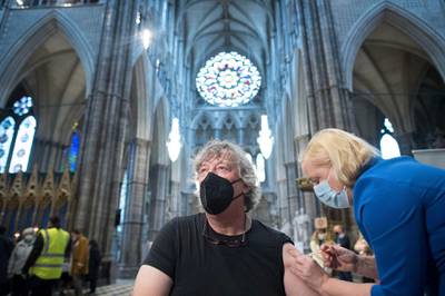 Actor Stephen Fry receives the vaccine at Poets' Corner in Westminster Abbey. AP Photo