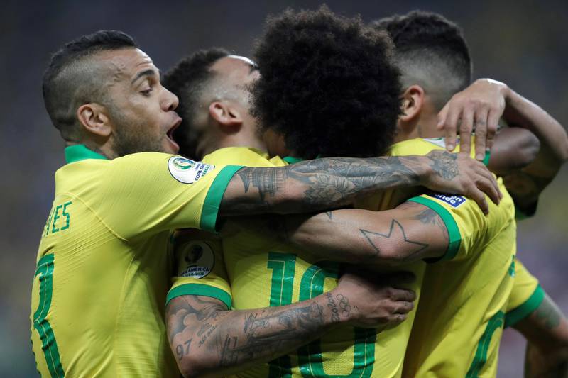 Brazil players celebrate a goal by Willian. EPA