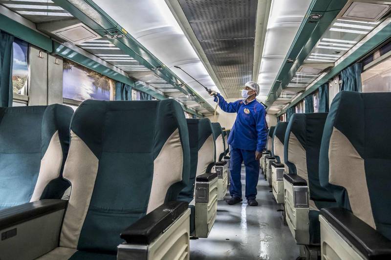 An Egyptian worker sprays disinfectant inside a train at Cairo's Ramses railway station. AFP