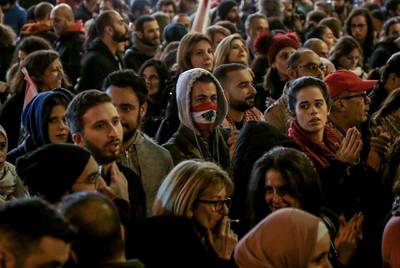 Protesters shout slogans against the parlianment members, during an anti-government protest in front of the Parliament building in Beirut.  EPA
