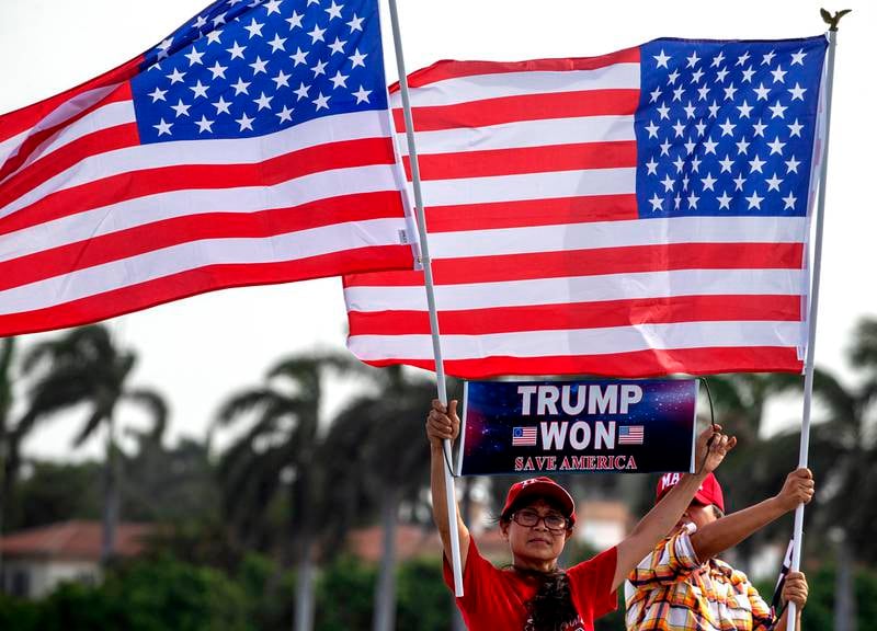 Trump supporters wave flags and hold signs outside Mar-a-Lago after the FBI carried out a search warrant at the former president's residence. EPA