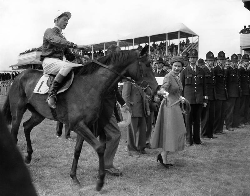 Queen Elizabeth II leading her Oaks winner Carrozza in with Lester Piggott in the saddle at Epsom in 1957. PA