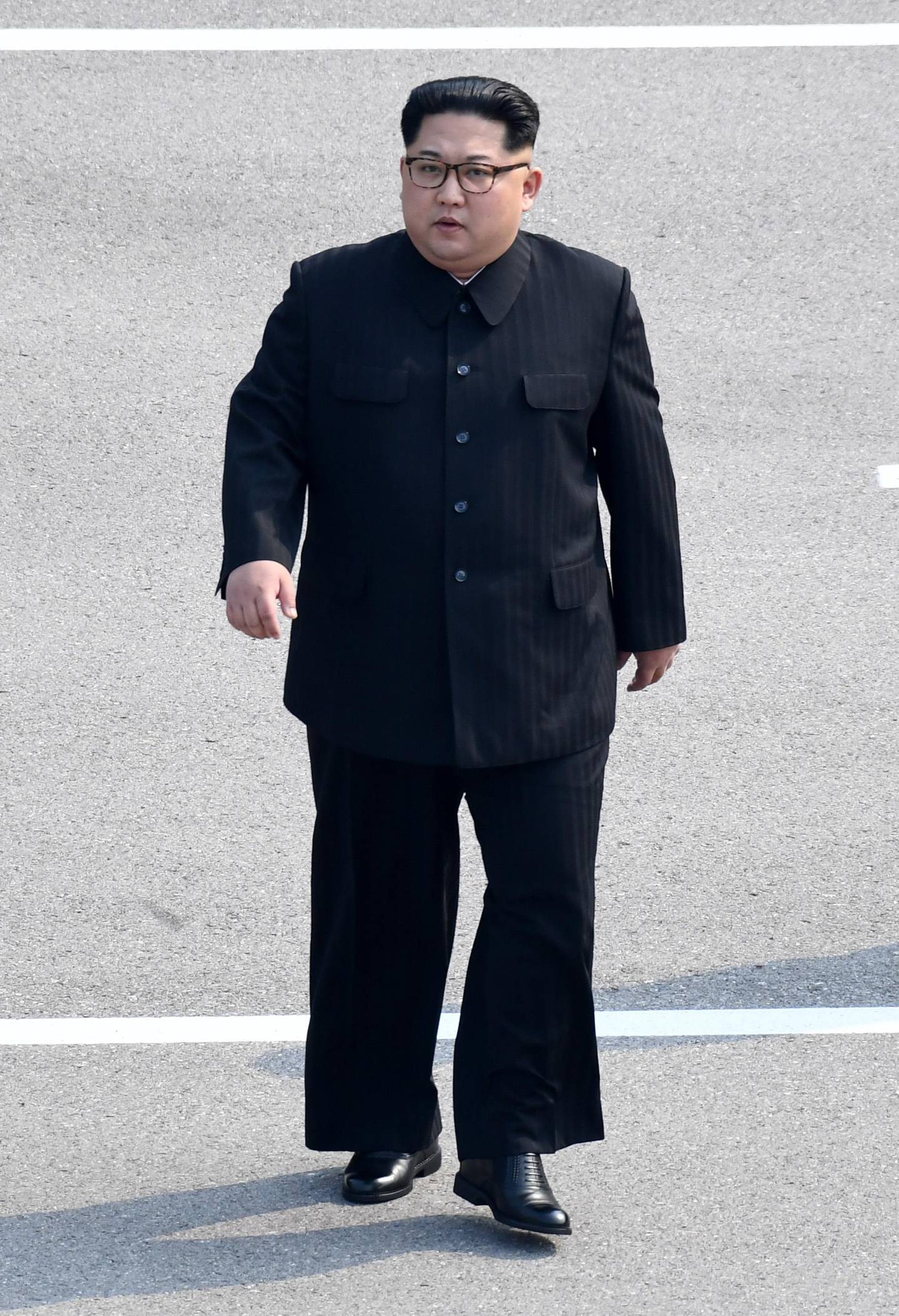 North Korea's leader Kim Jong Un walks from the North to the Military Demarcation Line that divides the two Koreas to meet with his South Korean counterpart at the truce village of Panmunjom on April 27, 2018.
North Korean leader Kim Jong Un and the South's President Moon Jae-in sat down to a historic summit on April 27 after shaking hands over the Military Demarcation Line that divides their countries in a gesture laden with symbolism. / AFP PHOTO / Korea Summit Press Pool / Korea Summit Press Pool