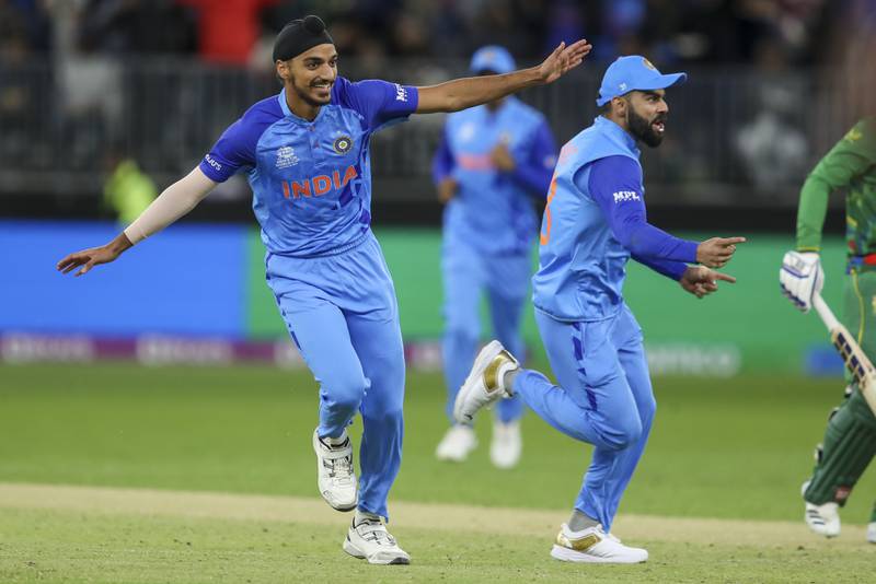 India's Arshdeep Singh, left, celebrates after dismissing South Africa's Quinton de Kock. AP 