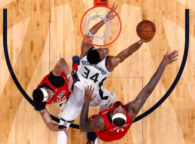 Milwaukee Bucks forward Giannis Antetokounmpo (34) drives to the basket between New Orleans Pelicans centre DeMarcus Cousins (0) and forward Anthony Davis (23) in the second half of an NBA basketball game in New Orleans. The Pelicans won 115-108. Gerald Herbert / AP Photo