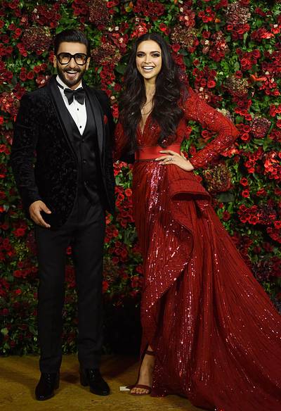 For a third wedding reception in Mumbai on December 1, Singh went ultra-classic in a black tux - but note the contrasting textures for an extra touch. AFP