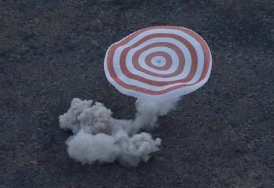 The Russian Soyuz TMA-16M space capsule, carrying the Expedition 44 crew member Gennady Padalka of Roscosmos and visiting crew members Andreas Mogensen and Aidyn Aimbetov, lands in a remote area outside the town of Zhezkazgan in Kazakhstan. Yuri Kochetkov / AFP