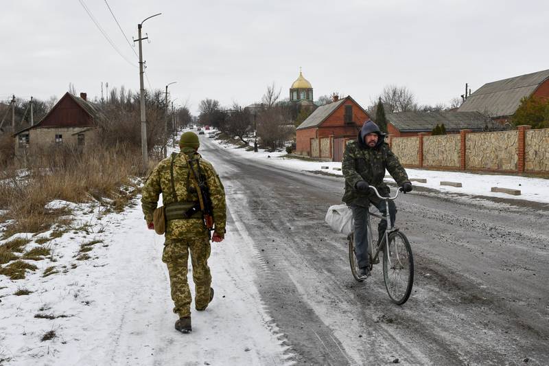 A Ukrainian soldier patrols a street near a frontline with Russia-backed separatists in Yasynuvata district, Donetsk region, eastern Ukraine. AP