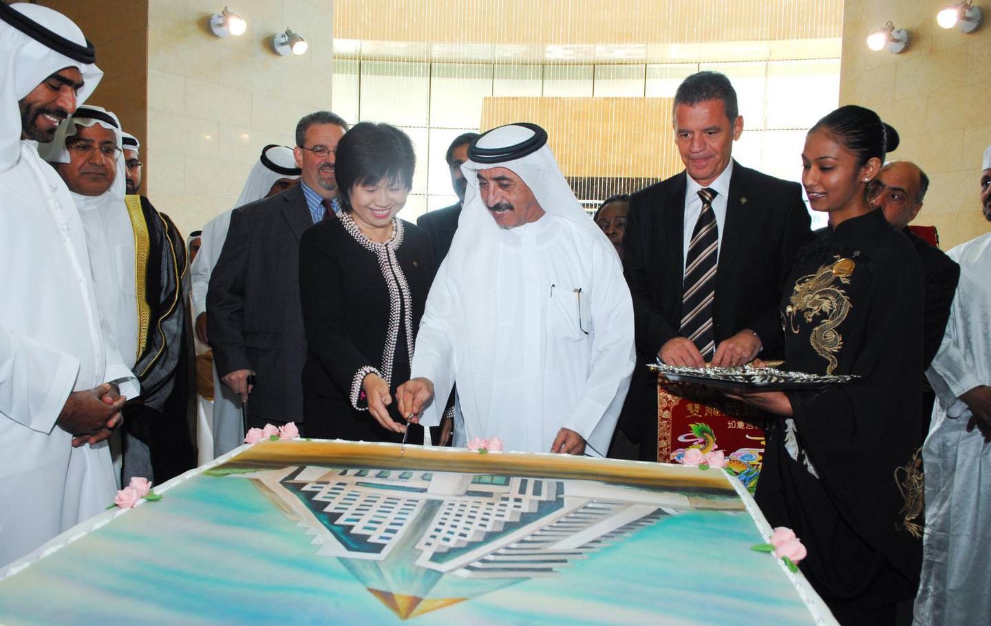 Sheikh Hasher bin Maktoum Al Maktoum and Diana Ee-Tan of Raffles cut into a giant cake as Raffles Dubai opens. Photo: Raffles Dubai