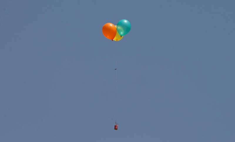 Flaming balloons are released by Palestinian demonstrators.  Mohammed Salem / Reuters