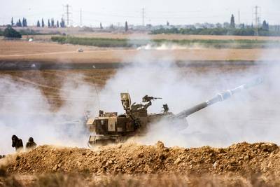 An Israeli army self-propelled howitzer fires rounds near the border with Gaza in southern Israel on Wednesday. AFP