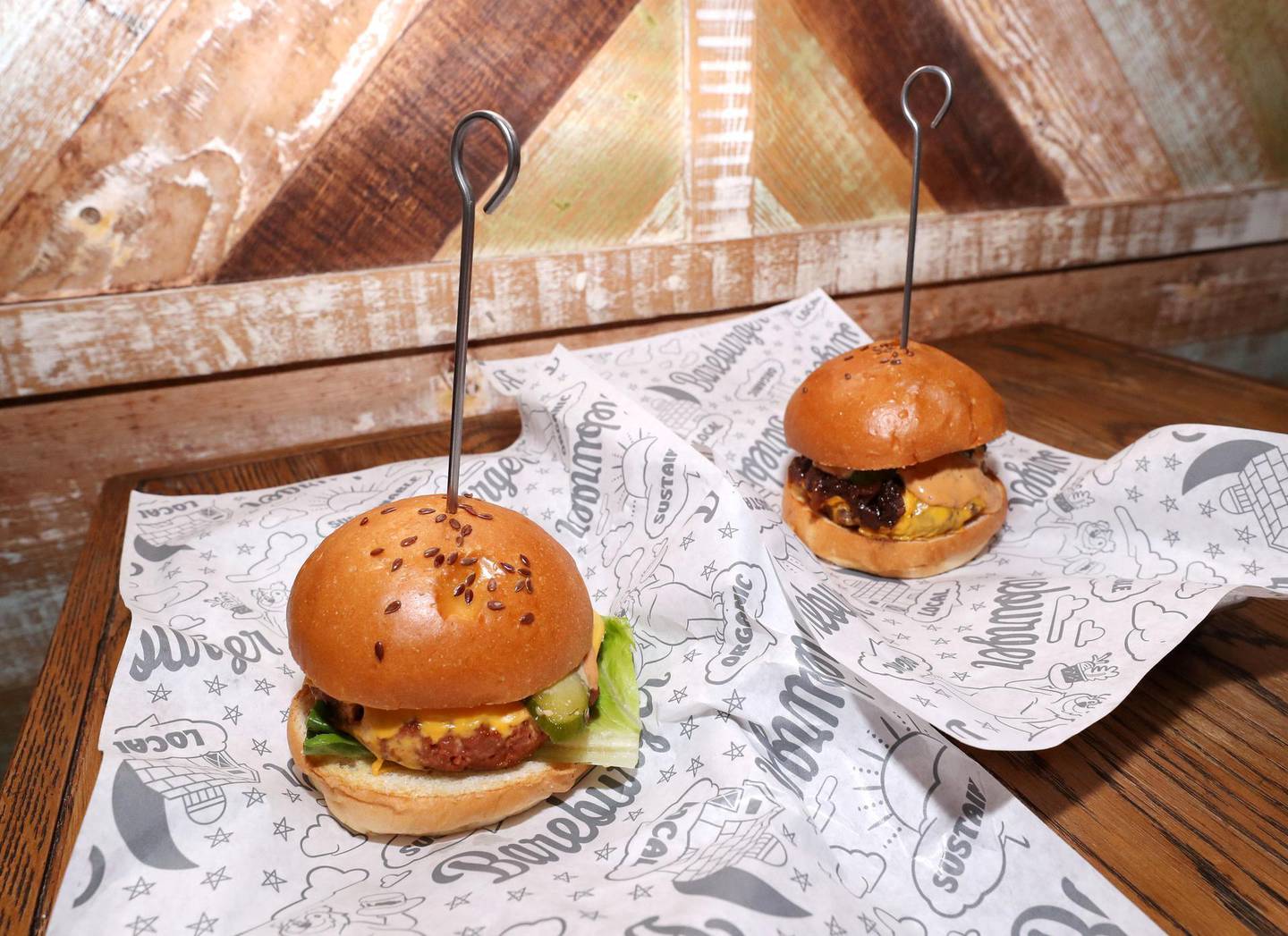 Dubai, United Arab Emirates - September 10, 2018: A comparison between the vegan burger (L) and the beef burger. Bareburger are launching a revolutionary plant-based (vegan) burger that looks, cooks and satisfies like beef. Monday, September 10th, 2018 at La Mer, Dubai. Chris Whiteoak / The National