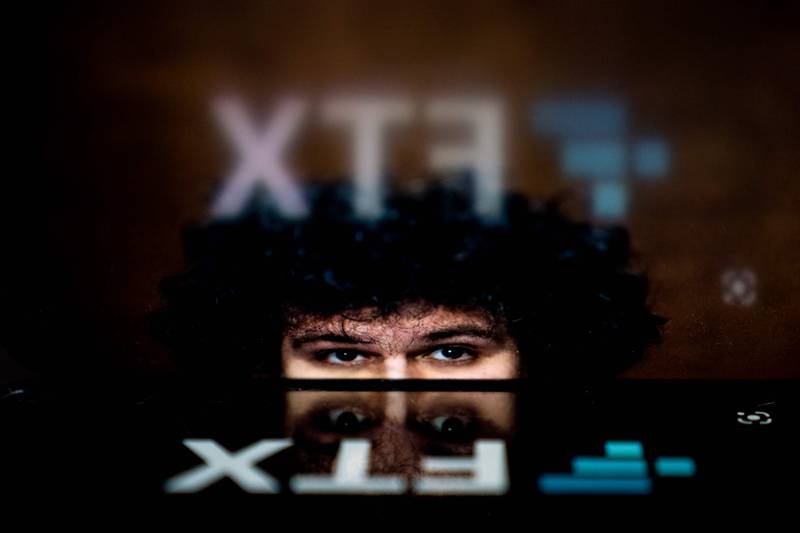 The logo of FTX, reflected in an image of former chief executive Samuel Bankman-Fried, in Washington this week. AFP