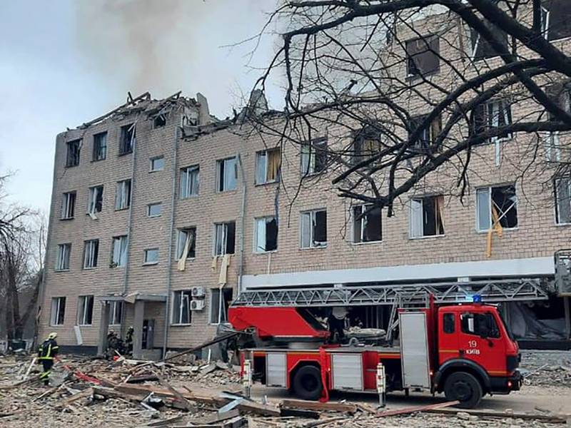 Firefighters arrive at a military building in Kiev that was damaged in an explosion. EPA