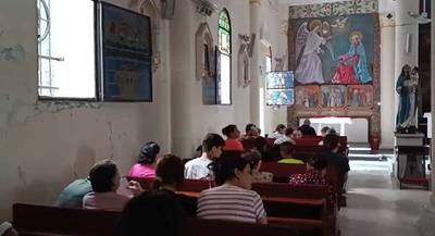 Parishioners pray for peace at the Holy Family Church in Gaza