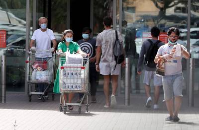DUBAI, UNITED ARAB EMIRATES , April 05 – 2020 :- People wearing protective face mask after doing shopping at the Carrefour supermarket in Ibn Battuta mall in Dubai. UAE government told residents to wear facemask and gloves all the times outside the home. (Pawan Singh / The National) For News/Online/Instagram.