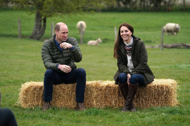 DARLINGTON, ENGLAND - APRIL 27:  Catherine, Duchess of Cambridge and Prince William, Duke of Cambridge sit on hay balls during a royal visit to Manor Farm in Little Stainton, Durham on April 27, 2021 in Darlington, England. (Photo by Owen Humphreys - WPA Pool/Getty Images)