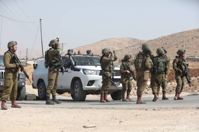 Israeli troops search the area near Atof village after the attack. EPA