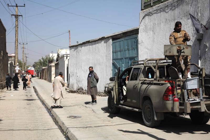 Taliban gunmen guard the site of the attack at the learning centre in Dasht-e-Barchi.  AFP