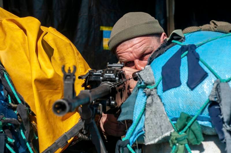 A Ukrainian fighter takes position in the eastern city of Kharkiv. EPA