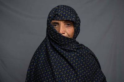 Knitter and garment maker Gul Guti, 55, poses for a portrait in Kandahar.