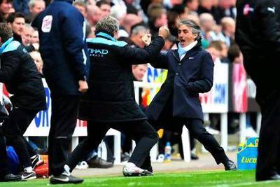 With one more game to be played and won in order for Manchester City to win their first top-flight title since 1968, Roberto Mancini, right, the manager, is hesitant to celebrate just yet. Stu Forster / Getty Images