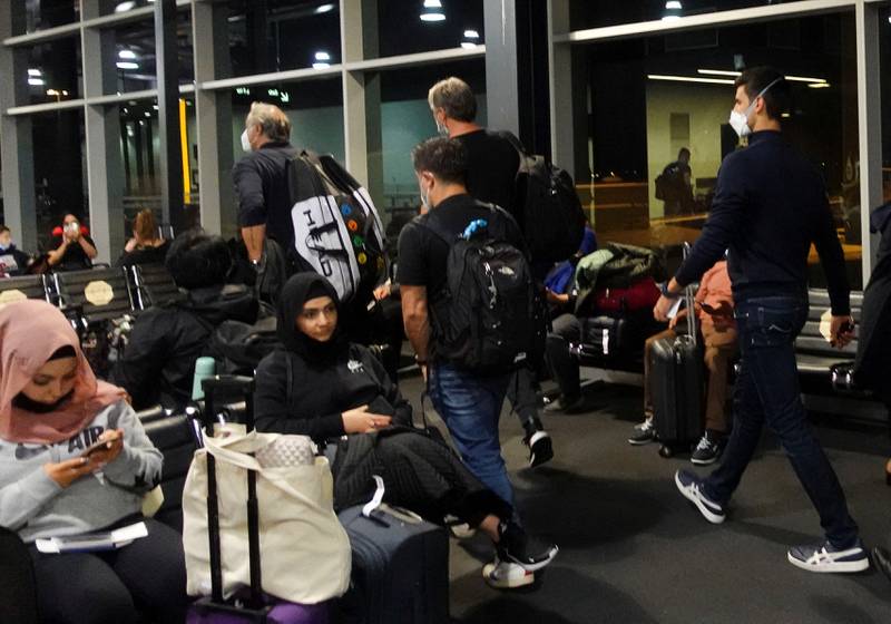 Serbian tennis player Novak Djokovic walks in Melbourne Airport escorted by aides. Reuters