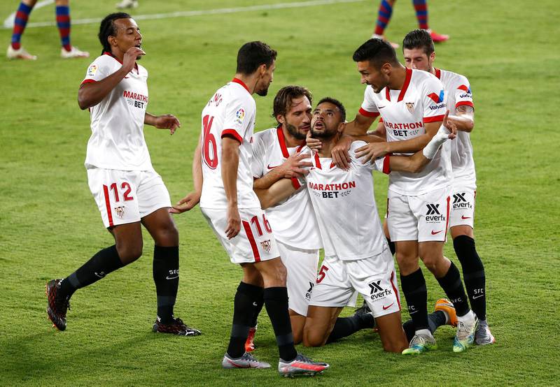 SEVILLE, SPAIN - OCTOBER 01: Yousseff En-Nesyri of Sevilla FC celebrates with his team mates after scoring his team's first goal during the La Liga Santander match between Sevilla FC and Levante UD at Estadio Ramon Sanchez Pizjuan on October 01, 2020 in Seville, Spain. Football Stadiums around Europe remain empty due to the Coronavirus Pandemic as Government social distancing laws prohibit fans inside venues resulting in fixtures being played behind closed doors. (Photo by Fran Santiago/Getty Images)