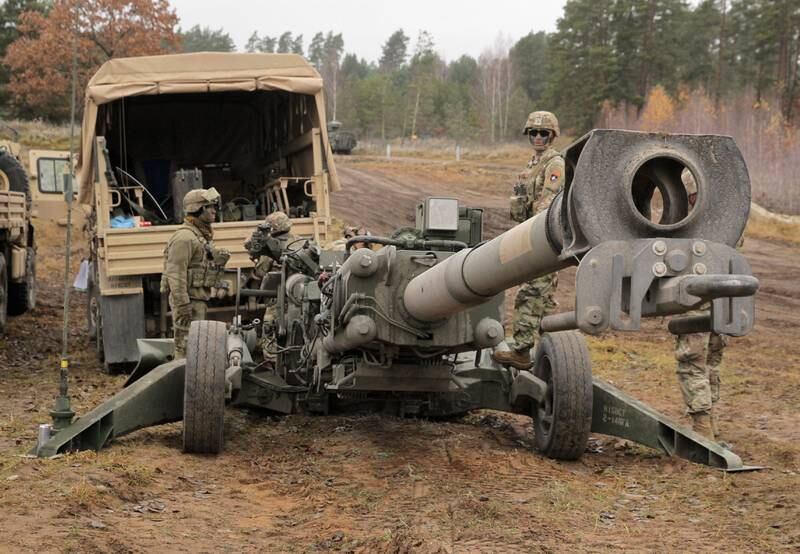 Soldiers get ready to use test a US Army M777 howitzer, scores of which are being sent to Ukraine, during Nato exercises at Orzysz training ground, north-eastern Poland. EPA