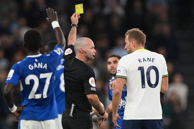 Harry Kane receives a yellow card from referee Paul Tierney. AFP