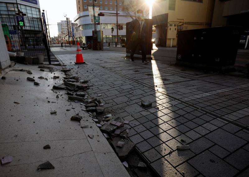 Collapsed exterior wall of a building caused by a strong earthquake are seen on the street in Iwaki, Fukushima prefecture, Japan. Reuters