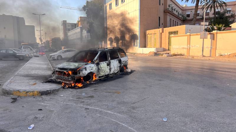 A car burns in the street. Reuters