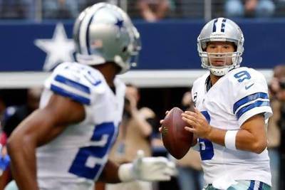 Dallas Cowboys quarterback Tony Romo looks to pass the ball.