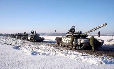 Russian tanks make their way through snow back to their bases. EPA