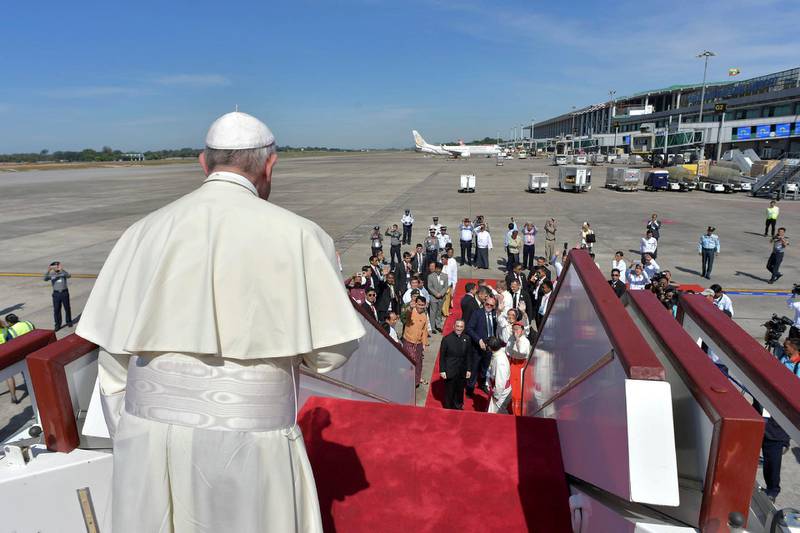 Pope Francis waves goodbye and boards his  plane for Dhaka, Bangladesh, from Yangon's International Airport, Myanmar. Osservatore Romano / Handout via Reuters