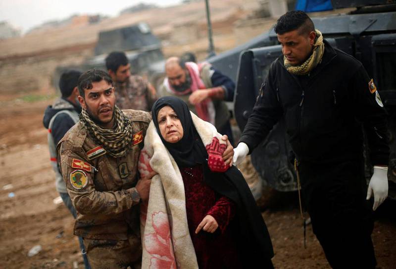 An Iraqi woman, who was wounded during clashes in the ISIL stronghold of Mosul, is brought into a field hospital inAl Samah neighbourhood, Iraq, on December 1, 2016. Mohammed Salem / Reuters