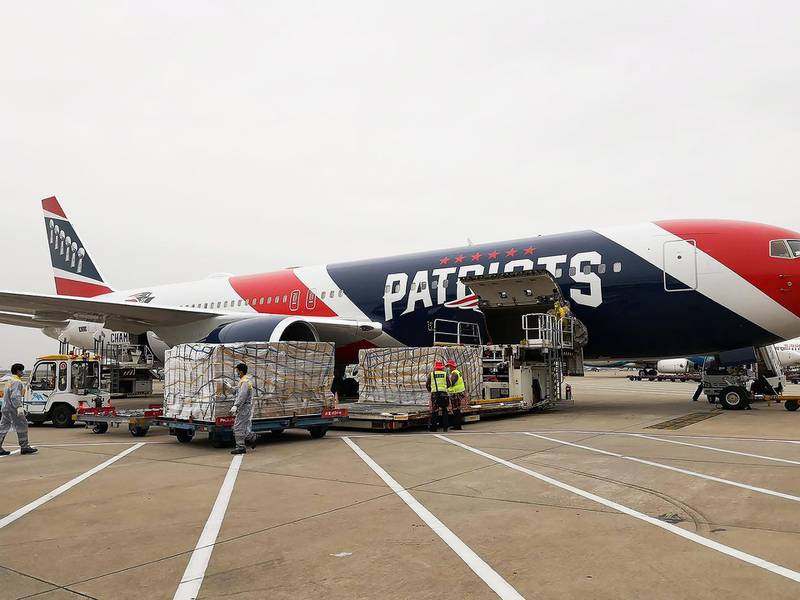 Workers load more than one million N95 masks into the New England Patriots team plane in Shenzhnen, China, on Thursday. Quaratine rules were lifted for the crew on the condition they remain on the plane and the plane only stayed for a few hours during the loading before heading back to Boston. EPA