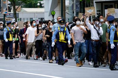 People march to protest during a solidarity rally for the death of George Floyd and against racism Saturday in Tokyo