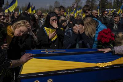 Relatives mourn next to the coffin of Ukrainian serviceman Andrii Vorobiov at the Kryvyi Rih cemetery in eastern Ukraine on Monday. AP Photo